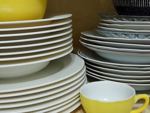 Plates and a yellow cup in the kitchen cabinet