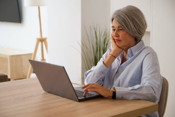 istock Focused senior freelancer working remotely from home office 2184542863