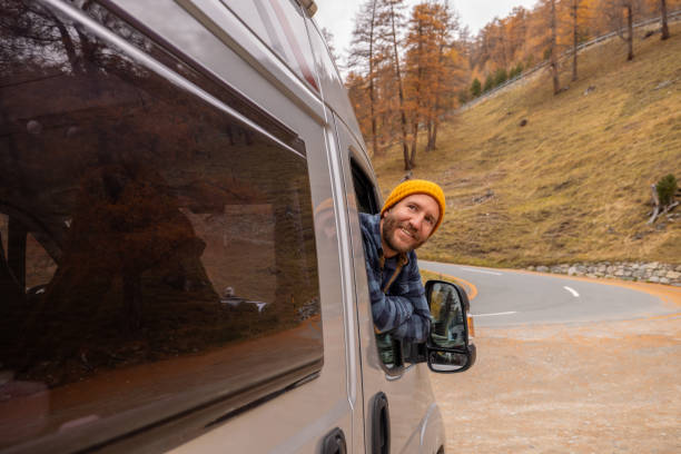 istock Man Enjoying Scenic Drive Through Autumn Landscape 2184544045