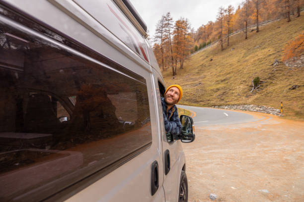 istock Man Enjoying Scenic Drive Through Autumn Landscape 2184544071