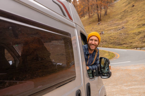istock Man Enjoying Scenic Drive Through Autumn Landscape 2184544087
