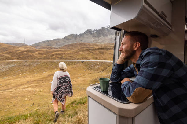 istock Couple Enjoying Scenic Mountain View from Camper Van 2184544190