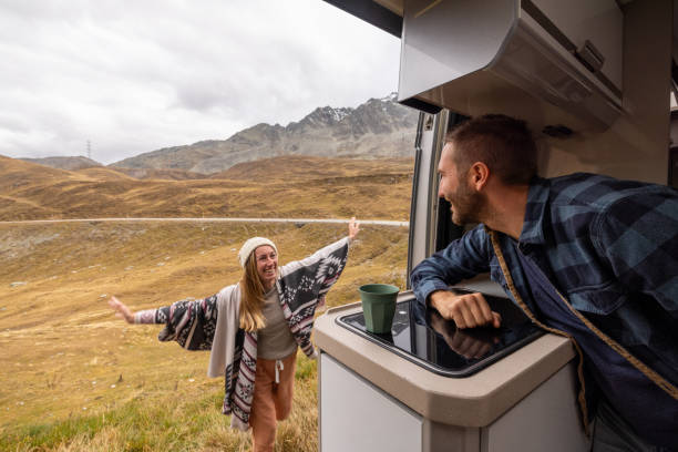 istock Couple Enjoying Scenic Mountain View from Camper Van 2184544239