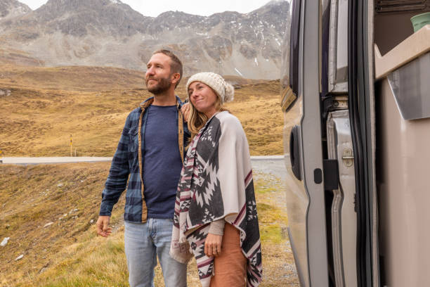 istock Smiling Couple Enjoying a Roadside Mountain Adventure 2184544257