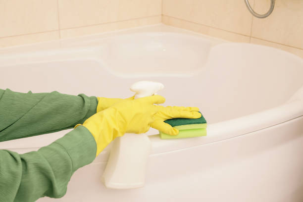 istock Hands Women Wearing Protect Glove Yellow using liquid Cleaning solution Cleaning Acrylic Bath, Disinfection and Hygiene Concept 2184546800
