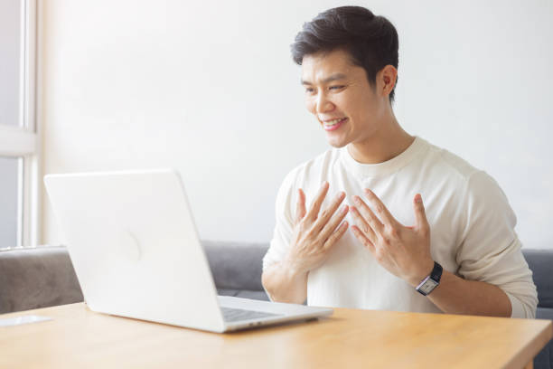 istock close up young asian man make gesture hand about sign language to teaching or talking to colleague on video conference program in office meeting room for business lifestyle concept 2184547723