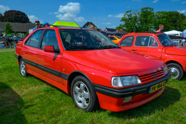 Peugeot 405 T16 performance sedan parked in a field. The T16 is equipped with a 2-litre turbocharged 4-cylinder engine supercharged by a Garett turbocharger.