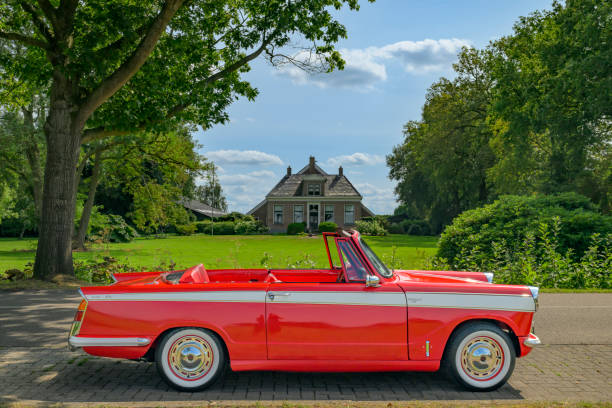 Triumph Herald 1300 Convertible classic British car parked on the side of the road. The car is on display during the annual Oldtimer day in Ruinerwold.