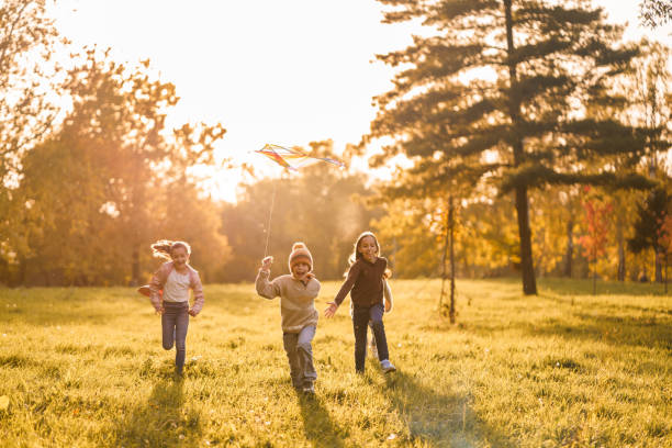 istock Playful children running whit kite on a meadow 2184552200
