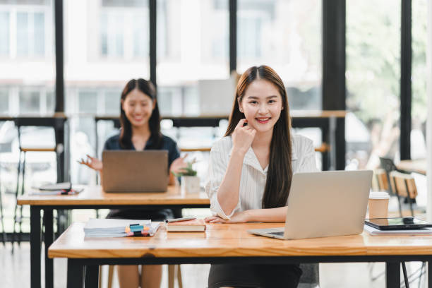 istock Efficient women working in modern office environment, focused on their laptops. bright space enhances productivity and collaboration, creating positive atmosphere. 2184554489
