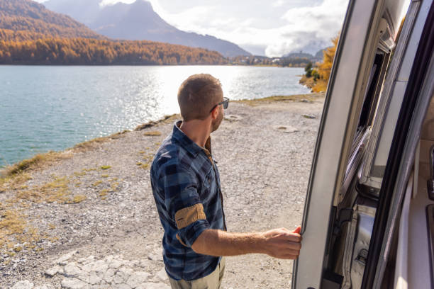 istock Man Enjoying Scenic Lake and Mountain View from Camper Van 2184554566