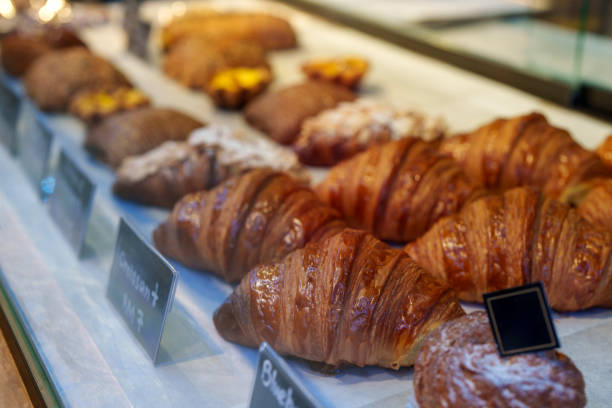 istock Freshly Baked Croissants and Pastries on Display in a Bakery 2184557081