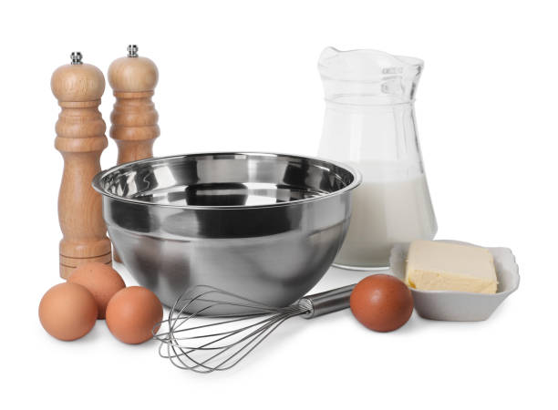 istock Metal whisk and dough ingredients isolated on white 2184565403