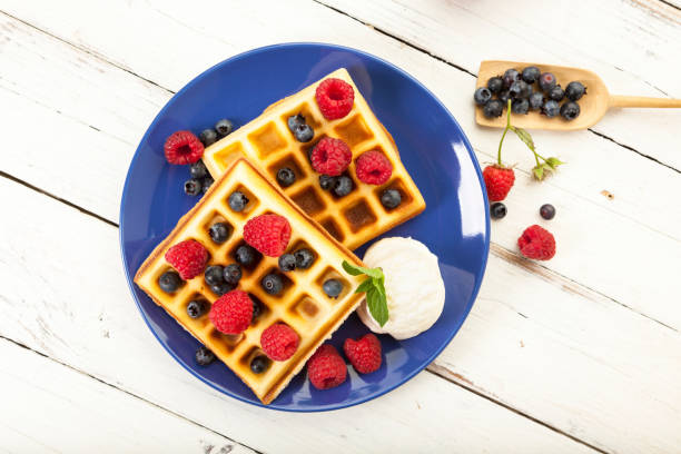 istock Belgian waffles with raspberries, blueberries and ice cream 2184565406