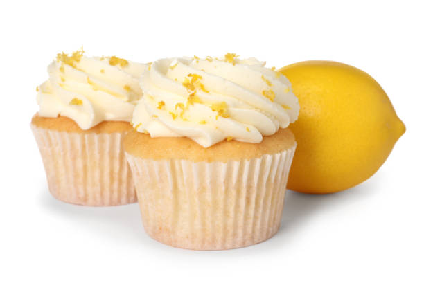 istock Delicious cupcakes with cream and lemon zest isolated on white 2184565456