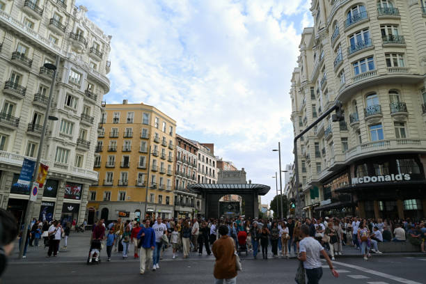 Madrid, Spain, october 6, 2024 : Tourists at the intersection of Gran Via and Montera Street in Madrid
