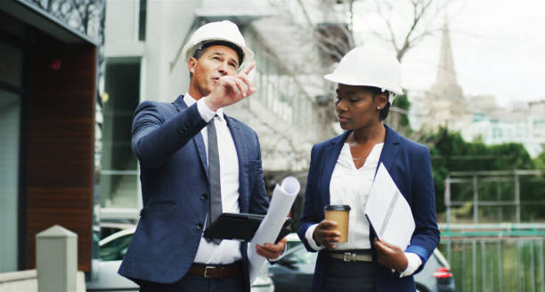 istock Engineering, people and tablet in city for planning, urban development and project management. Architecture team, discussion and pointing with tech for inspection, contractor feedback and business 2184569247