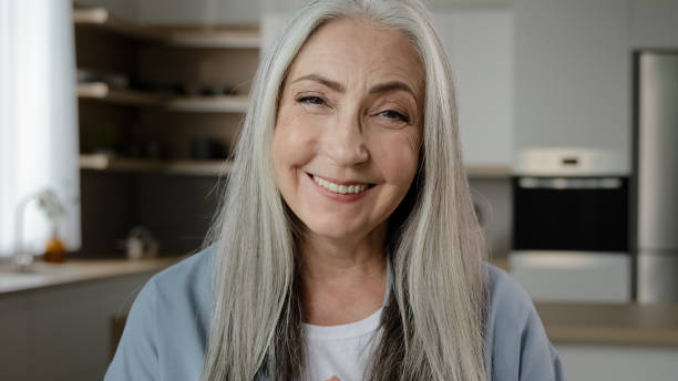 istock Positive elderly retiree woman look at web camera happy 70s granny calling online distant video chat with family in quarantine time virtual internet connection smiling mature adult lady talk to webcam 2184570597