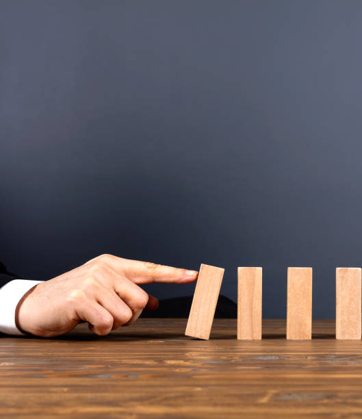 istock Businessman hand stop domino effect 2184571574