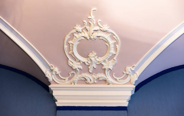 istock White bas-relief decoration details over blue pink ceiling and wall 2184573985