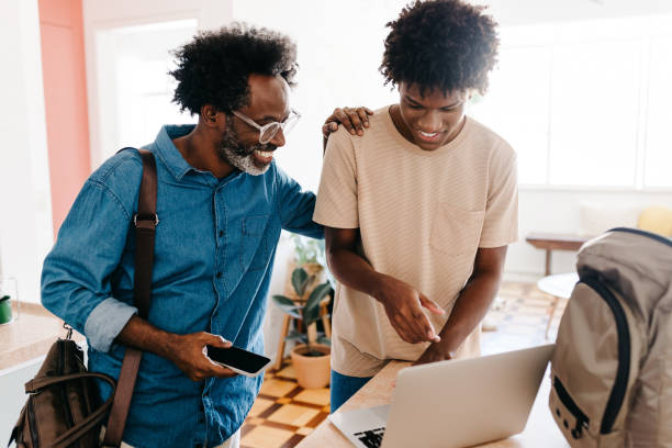 istock Afro father and son start their happy morning routine together using laptop 2184574543