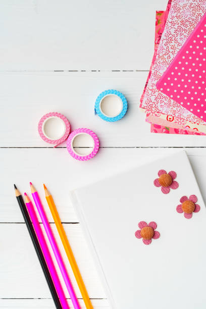 istock Crafting a colorful workspace with decorations, stationery, and artistic tools on a clean wooden surface 2184575471