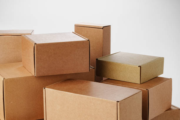 istock Stacked brown cardboard boxes in various sizes arranged on a white background 2184575505