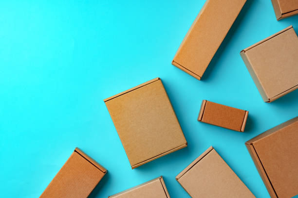 A collection of cardboard boxes arranged on a bright blue surface
