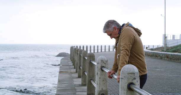istock Mature man, thinking and stress by ocean with outdoor, planning or reflection for break on weekend. Male person, mental health and wellness by seaside, beach or water for ideas, memory or mindfulness 2184576203