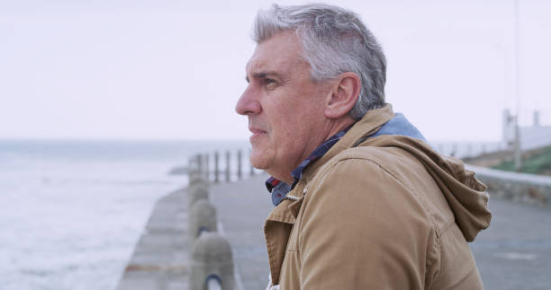 istock Thinking, relax and memory with old man at beach for reflection, mental health and inspiration. Perspective, vision and mindset with senior person contemplating outdoors for decision and break 2184576205