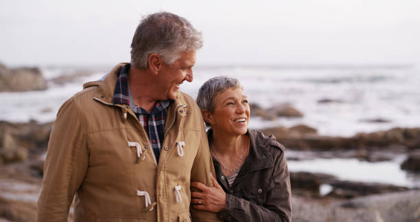 istock Happy, holding hands and old couple by ocean walking for bonding, relationship and relax together. Nature, marriage and man and woman by sea talking for romance, commitment and love on weekend 2184576455