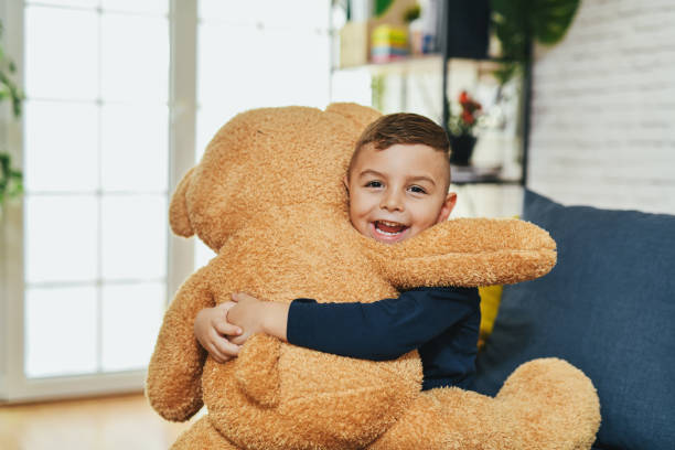 Cute Joyful Boy Smiling and Hugging His New Teddy Bear Not Wanting to Separate From it