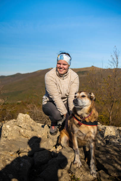 istock Woman enjoying nature with her dog 2184580787