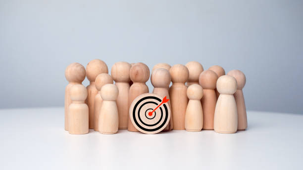 istock Wooden dolls standing around dart board for creating and targeting business objectives. Target concept of business and personnel in a company. Marketing solutions, targets for business investment. 2184582261