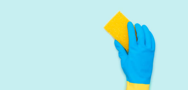 istock Cleaning services, hand with a yellow sponge 2184582308
