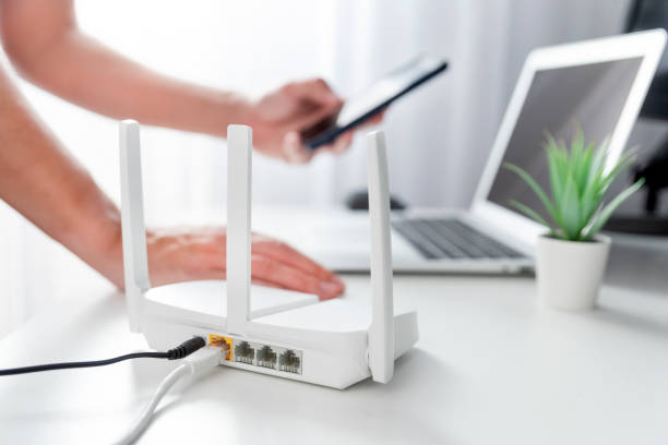 istock Modern wi-fi router on light table in room 2184582370
