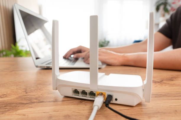istock Modern wi-fi router on light table in room 2184582390