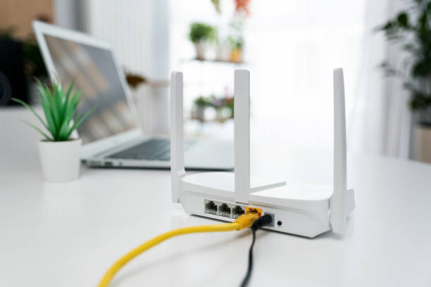 Modern wi-fi router on light table in room
