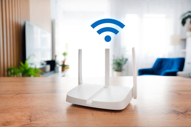 istock Modern wi-fi router on light table in room 2184582411