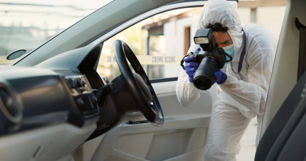 istock Person, forensics and digital camera in car at crime scene for hijacking, murder and investigation. Employee, photography and outdoor for evidence or inspection on accident, robbery or stolen vehicle 2184583879