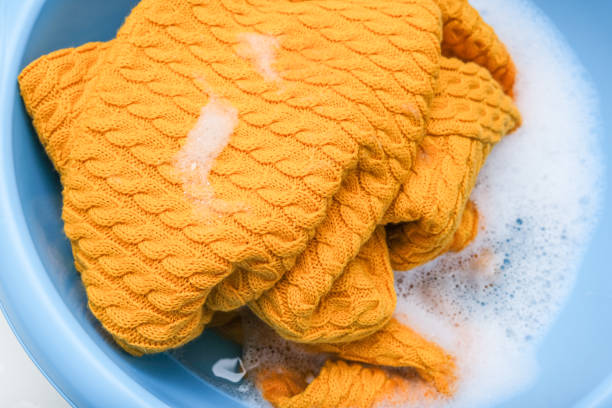 Hand washing of delicate woolen knitted clothes, sweaters concept.