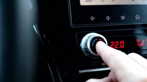 istock Driver hand tuning temperature control knob in car air conditioning system close up, comfort and fresh air in vehicle cabin. 2184584610