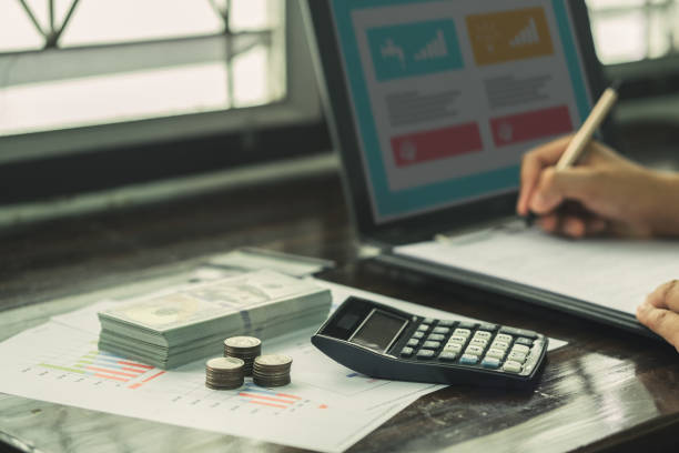 istock People are using computer to do online financial transactions such as debt, investment, calculation. Retro photo of economic downturn, stress. 2184585211