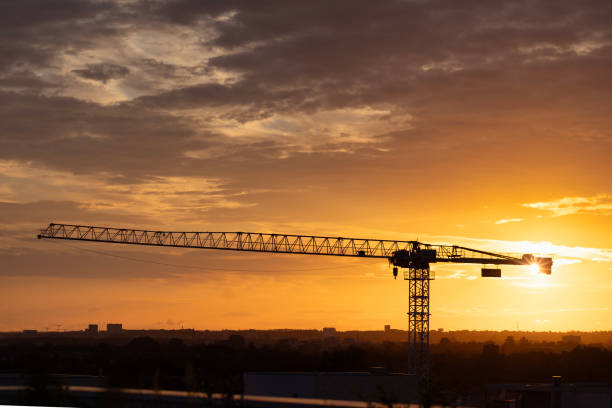 istock New construction site with crane and mechanical equipments on sunset background. 2184586733