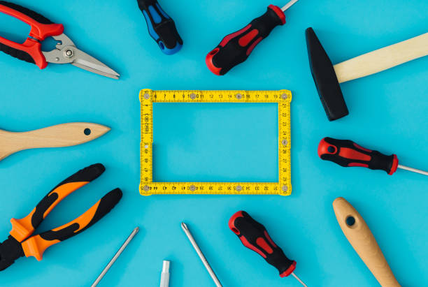 Pattern made of household tools with creative carpenter wooden folding ruler copy space on blue background. Minimal hand working tools concept. Trendy household tools idea. Flat lay.