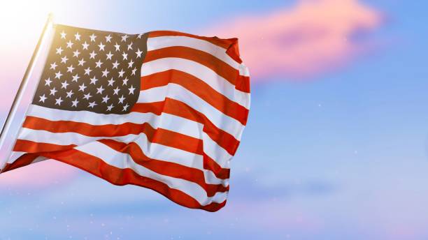 istock American Flag Waving Against Sunset Sky. 2184599692