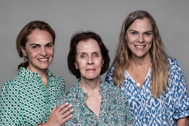 istock Old lady posing with her two daughters on gray background 2184599883
