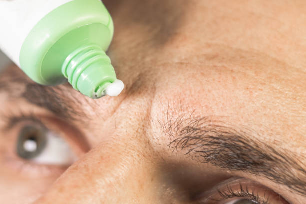 istock Man is applying anti wrinkles cream.Frown lines between eyebrows on mans face. Vertical wrinkles, close up. 2184601563