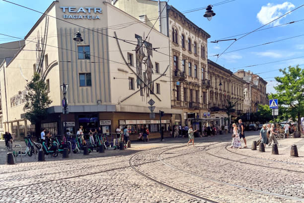 Krakow, Poland - July 27, 2024 : View of incidental people in a pedestrian area around electric push scooter