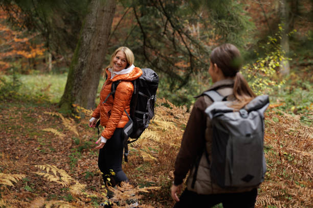 istock Two Women Enjoying a Scenic Hike Through Autumn Forest 2184602009